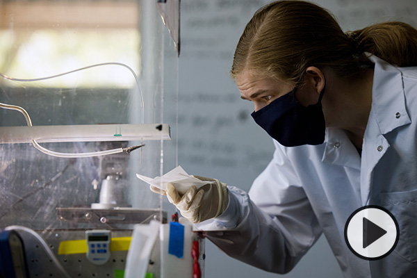 A woman works in a lab to spin nanofibers for more effective masks