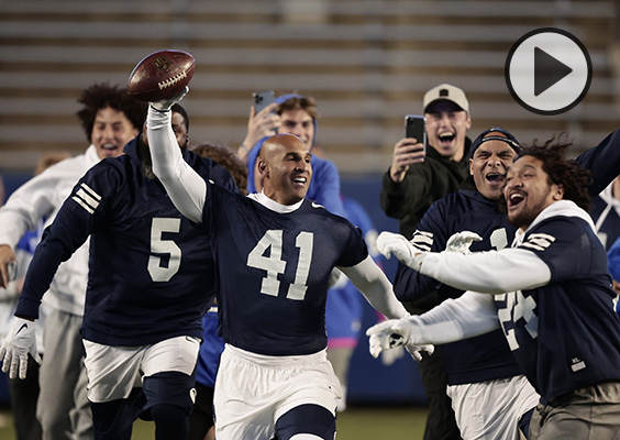 Bryan Kehl celebrates with the football after scoring a tuchdown in the first BYU alumni game.