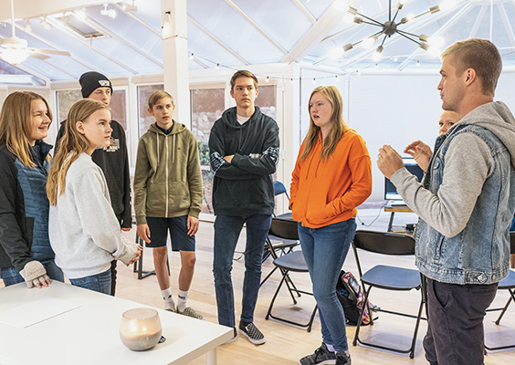 Travis Lish (right) found a meaningful role for himself by cultivating teens’ talents and teaching them to be successful entrepreneurs. Photo by Bradley Slade.