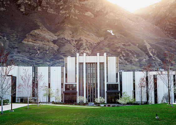 The sun rises over Y Mountain behind the J. Reuben Clark Law School Building.