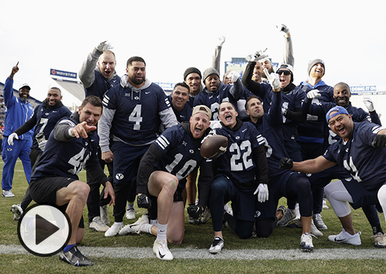 Team Navy celebrates together after a 26-20 victory over Team Royal in the second annual alumni game. | Photo by Jaren Wilkey.
