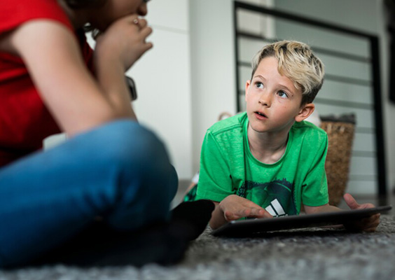 A young boy on a laptop looks to an older family member for guidance. Photo by Nate Edwards. When parents critically engage with the content their children view, they are better equipped to help their children understand the influence the content has on their attitudes and behavior.