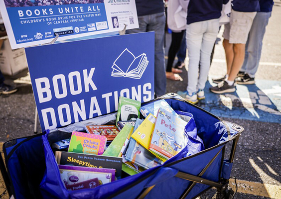 A book donation bin full of books from a service tailgate effort before the BYU football game at Liberty University in Lynchburg, Virginia. BYU alums, fans and friends donated more than 1,500 books for schoolchildren.