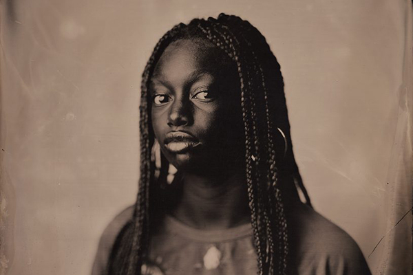 A tin-type photograph of a Black woman.