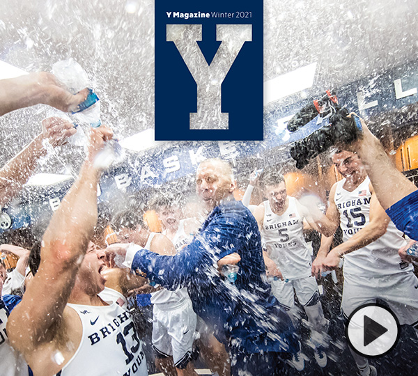 Mark Pope and the 2020 BYU basketball team celebrate with water bottles in the locker room after a big win.