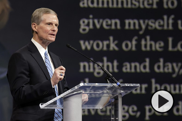 Elder David Bednar speaks in the Marriott Center at a BYU devotional.