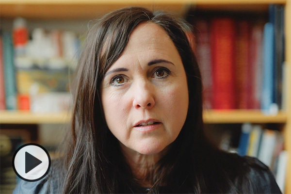 BYU family-life professor Chelom Leavitt in front of some bookshelves.