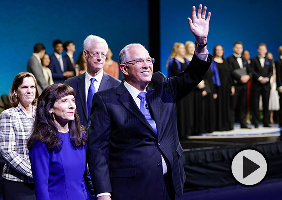 Elder Neil L. Andersen of the Quorum of the Twelve Apostles and his wife, Sister Kathy Andersen, wave to students gathered in the Marriott Center in Provo, Utah, for the weekly campus devotional on Tuesday, Jan. 17, 2023. Photo by Christi Norris, BYU.