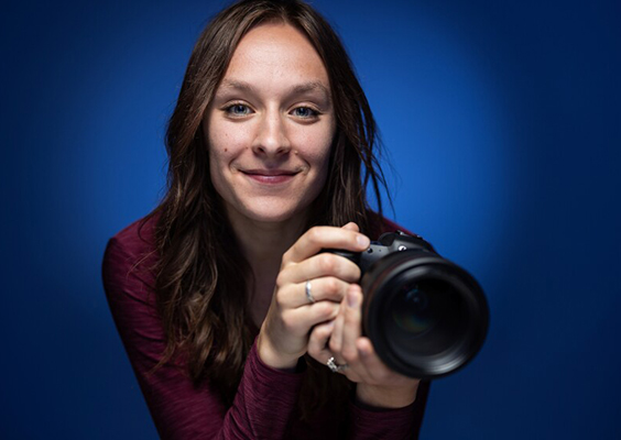 Shown here holding her camera, BYU student photographer Brooklynn Jarvis Kelson was named UPAA Student Photographer of the Year.