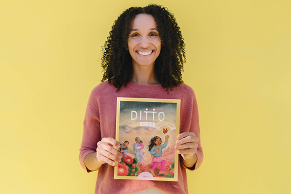 Alexandria Scott stands holding her first issue of Ditto Kids magazine after receiving funding on Kickstarter. Photo by Amy Hashimoto.