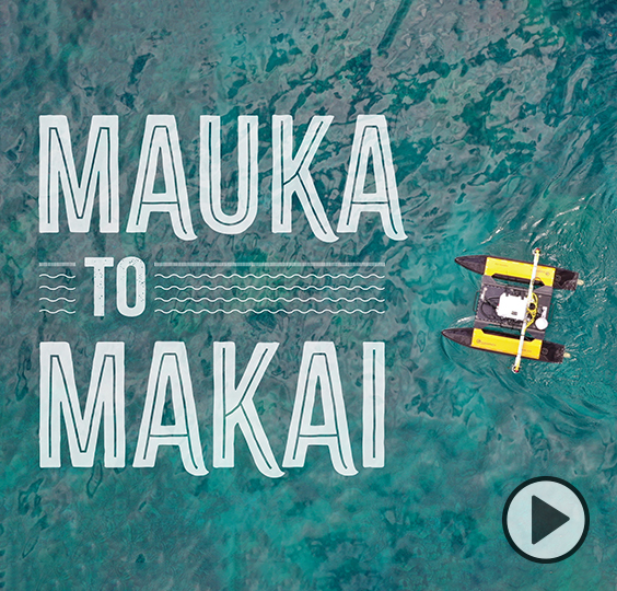 An aquatic drone floats on a calm ocean, a coral reef framed by turquoise water, next to thte words Mauka to Makai.