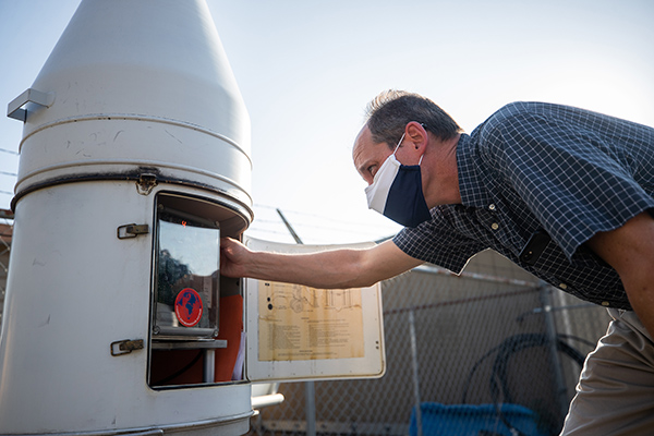 BYU geography professor Matt Bekker checks a weather station.