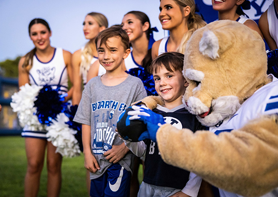 Cosmo and the spirit squad meet with fans at a park.