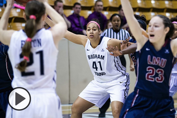 A BYU women's basketball player is about to throw the basketball to a teammate.