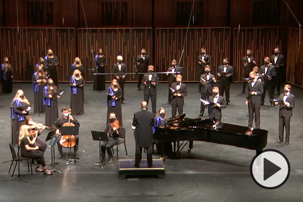 The BYU Singers and some stringed instrumentalists perform in the de Jong Concert Hall of the Harris Fine Arts Center.