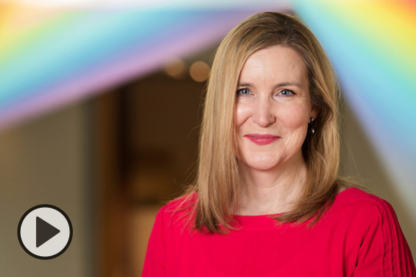 Janalee Emmer of BYU’s Museum of Art stands in front of an art piece by Gabriel Dawe titled Plexus No. 29.