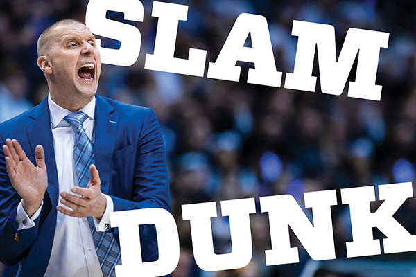 Head coach Mark Pope in a blue suit and blue tie yells and claps during a game. The words Slam Dunk appear at right.