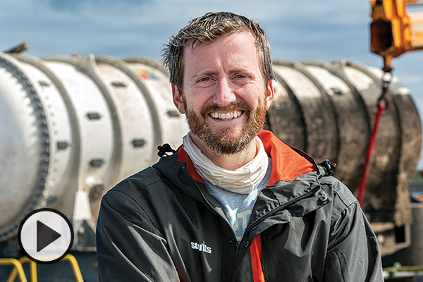 Spencer Fowers standing in front of an underwater computing lab.