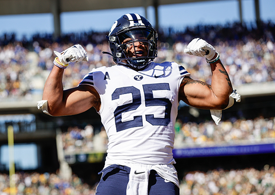 Running back Tyler Allgeier flexes his biceps after a big play.