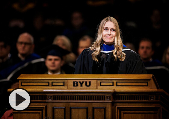 Hillary Nielsen, president of the BYU Alumni Association, at the Marriott Center podium.