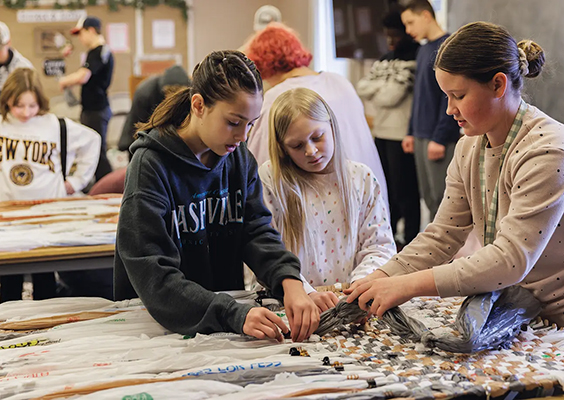 Youth in Spanish Fork, Utah, contribute to a JustServe project turning plastic bags into mats for refugees. Photo by Bradley Slade.