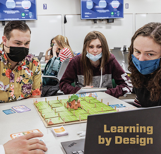 Learning by Design | In the library's Experiential Studio, students work on a prototype of a card game they are designing.