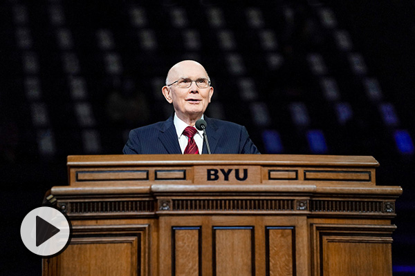 President Dallin H. Oaks stands at the podium of the BYU Marriott Center.
