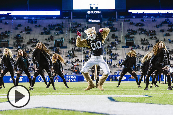 Cosmo and the Cougarettes perform before a socially distanced stadium crowd.