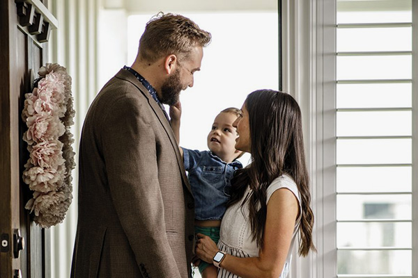 A family says goodbye at the front door.