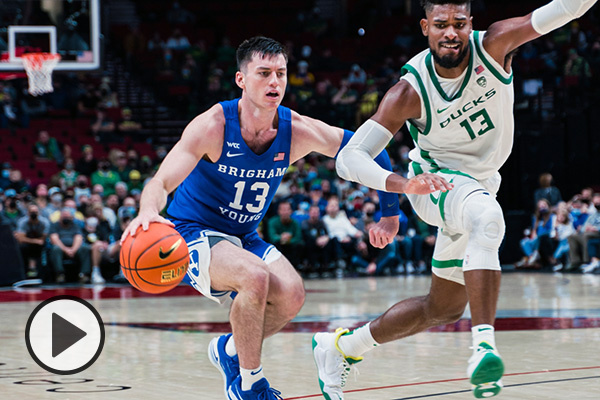 BYU guard Alex Barcello dribbles the ball by an Oregon defender.