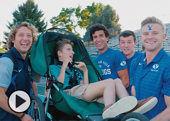 A child with a medical condition poses with BYU athletes at BYU's annual Courageous Kids Invitational.