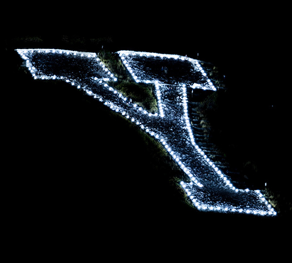 Closeup of the Y, its perimeter lit with bright LEDS.