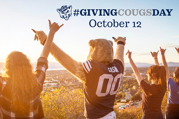 Giving Cougsday Oct. 12. Cosmo and some BYU students raise double shaka hands as they look over Utah Valley.