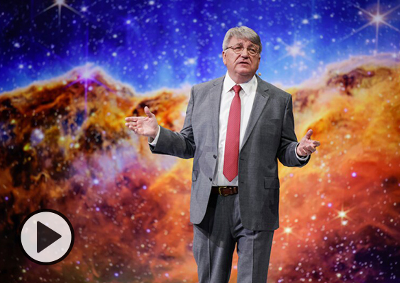 Paul Cox delivers a BYU forum in front of a constellation image. Photo by Christi Norris/BYU.