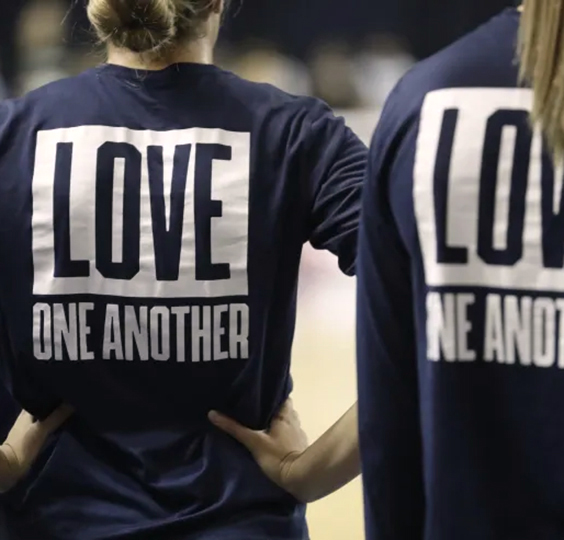 BYU women’s volleyball players wear “Love One Another” shirts during Thursday night’s match. BYU Photo