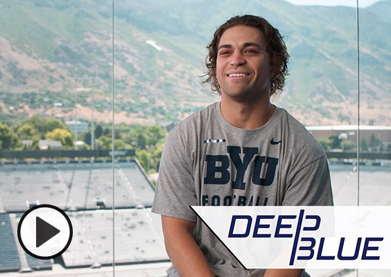 Lopini Katoa smiles as he shares his story from the glass windows of the football stadium pressbox.