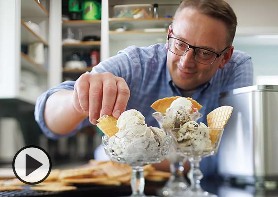 Professor Jacob Rawlins garnishes glass bowls of homemade ice cream with waffle chips. Photo by Bradley Slade.