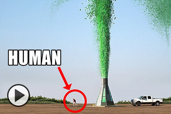 A space capsule-shaped 5-ton elephant toothpaste flask launches green goo skyward. A white pickup and a tiny human are pictured for scale.