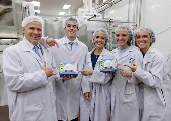 President Reese and his family, dressed in food safety gear, demonstrate visited the president;s new flavor of BYU Creamery ice cream.