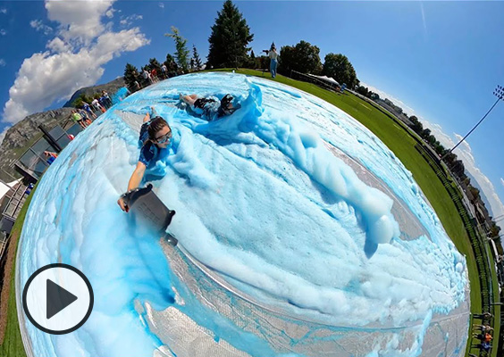 A 360 view of a student sliding through blue foam.